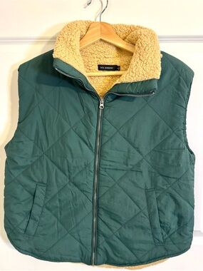 Blu Pepper quilted puffer vest in hunter green with tan sherpa lining.